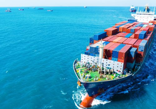 front view Cargo Container ship in the ocean ship carrying container and running for import export concept technology freight shipping by ship